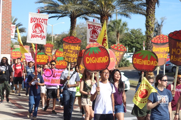 Students at the University of Florida join farmworkers for a march through campus during the Workers' Voice Tour stop in Gainesville, Florida