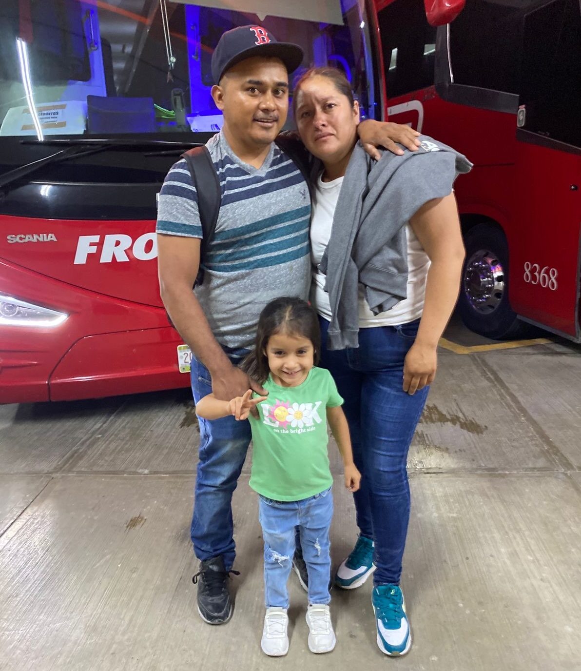 Marco Antonio Hernandez Guevara taking one last family photo with his wife and youngest daughter, 4, before boarding the bus to work as an H-2A worker in the US this summer