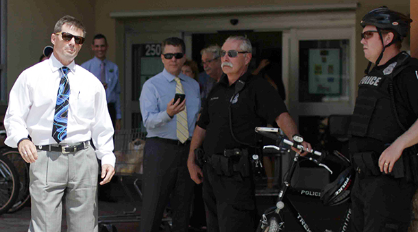 A typical sighting of Publix executives, flanked by local police, during Fair Food rallies  (March 2015)