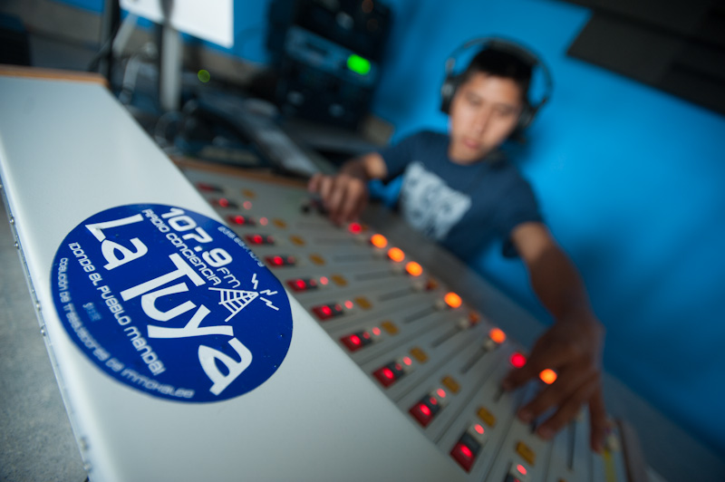 CIW's Leonel Perez at the control board of CIW's 12-year-old low-power FM radio station, Radio Conciencia.